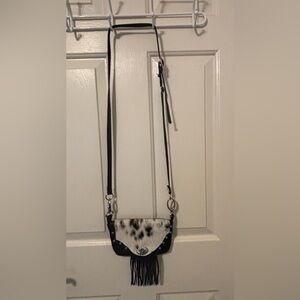 Handcrafted leather fringe bag with turquoise and silver concho